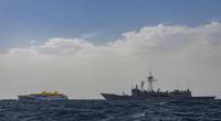 Bajamar Expess trimaran being escorted by the Spanish frigate ESPS Santa Maria
