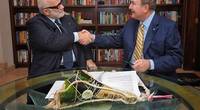 Manfredi Lefebvre D’Ovidio (left) shakes hands with Richard D. Fain after signing a deal that gives Royal Caribbean a 66.7 percent stake in Silversea (Photo: Silversea Cruises)