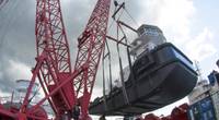 As the crane swing on its 60-foot diameter ring, the tug had to be lifted to clear winches and containers on the barge deck. (Photo: Haig-Brown / Cummins)