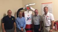 New Resolve Partners Chauncey Naylor (director of the Resolve Academy), Stacy Payne (Resolve) and Glyn Day and Neil Cooper both with Fire Ranger.
The Large Fire Extinguisher is called Big Red. (Image: Resolve Marine)