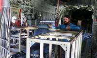 VX-30 engineer Sam Newcomer explains the Satellite Communications Range Extension Aircraft Modification (SCREAM) system inside a KC-130T Hercules at Naval Base Ventura County. The system enabled beyond-line-of-sight communications during Exercise Talisman Sabre 2025, supporting the U.S. Army’s first Typhon missile launch outside the continental United States. (U.S. Navy photo by Michael L. Smith)