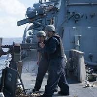Sailors aboard Arleigh Burke-class guided-missile destroyer USS Curtis Wilbur (DDG 54) fire a M2HB .50-caliber machine gun during a gunnery exercise in the South China Sea. Curtis Wilbur is on patrol in the 7th Fleet area of responsibility in support of security and stability in the Indo-Asia-Pacific region. (U.S. Navy photo by Lt.j.g. Jonathan Peterson/Released)