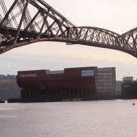 11,300t section of HMS Queen Elizabeth passing under the Forth Bridge as it nears the end of the journey to Fife