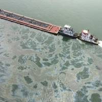 A barge loaded with marine fuel oil sits partially submerged in the Houston Ship Channel, March 22, 2014. The bulk carrier Summer Wind, reported a collision between the Summer Wind and a barge, containing 924,000 gallons of fuel oil, towed by the motor vessel Miss Susan. (USCG photo)