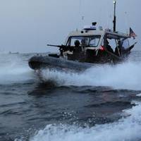 A boat crew from U.S. Coast Guard Port Security Unit (PSU) 313, from Everett, Wash., conducts a security patrol in a 4th generation, 32-foot transportable security boat (TSB) off the coast of Dogu beach in support of exercise Foal Eagle, April 21, 2013. PSU 313 along with Republic of Korea military forces, provided 24-hour water-side and shore-side force protection during Foal Eagle, a Combined/Joint Logistics Over-the-Shore Exercise (C/JLOTS). (U.S. Coast Guard photo by Petty Officer 2nd Class 