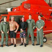A Coast Guard Air Station Corpus Christi MH-65 Dolphin helicopter aircrew stands with two rescued divers after they were located and rescued Saturday, June 27. (U.S. Coast Guard photo)