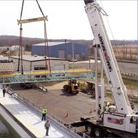 A crane replaces a bridge over the Ohmsett Oil Spill Response & Renewable Energy Test facility during refurbishment in spring 2022. (Photo: BSEE)
