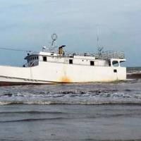 A derelict vessel, Rich, aground on Sargent Beach Thursday, located about 20 miles south of Freeport. USCG photo