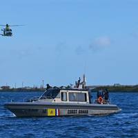 A Dutch Caribbean Coast Guard AW139 helicopter flies above a Metal Shark 38 Defiant patrol boat following a commissioning ceremony in Aruba on January 23rd, 2019.