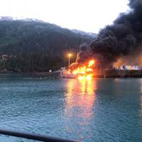 A fire burns at Delong Dock after an explosion on fixed barge in Whittier, Alaska, July 8, 2019. In addition to Coast Guard crews, response efforts included members of the Whittier Fire Department, Whittier Police Department, Anton Anderson Memorial Tunnel Fire Department and Girdwood Fire Department. Photo courtesy of Coast Guard Sector Anchorage.
