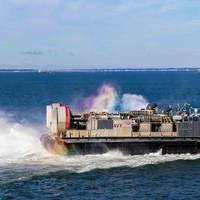A landing craft air cushion assigned to Assault Craft Unit 4, exits the well deck of the San Antonio-class amphibious transport dock USS San Antonio (LPD 17) while in port. Photo by US Navy/Savannah Hardesty