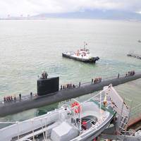 A pair of tug boats pull the Los Angeles-class fast attack submarine USS Santa Fe away from the submarine tender USS Frank Cable after a port visit to Subic Bay, Philippines. Frank Cable conducts maintenance and support of submarines and surface vessels deployed in the U.S. 7th Fleet area of responsibility. (U.S. Navy photo by Petty Officer 1st Class Ricardo Danan)