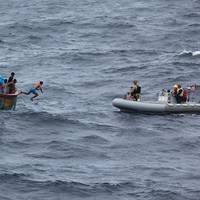A Sri Lankan fisherman jumps and swims to a rigid-hull inflatable boat from the Arleigh Burke-class guided missile destroyer USS Decatur (DDG 73) after the ship stopped to render assistance to a stranded fishing vessel. (U.S. Navy photo)