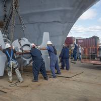 A team of shipbuilders replaces USS Abraham Lincoln’s anchor with one removed from USS Enterprise. Lincoln is undergoing a refueling and complex overhaul at Newport News Shipbuilding at the same time Enterprise is being inactivated. Photo by Ricky Thompson/HII