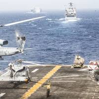 A UH-1Y Venom helicopter assigned to Marine Medium Tiltrotor Squadron (VMM) 163 (Reinforced), 11th Marine Expeditionary Unit (MEU), takes off from the flight deck of the amphibious assault ship USS Boxer (LHD 4) during a strait transit. The Boxer Amphibious Ready Group and the 11th MEU are deployed to the U.S. 5th Fleet area of operations in support of naval operations to ensure maritime stability and security in the Central Region, connecting the Mediterranean and the Pacific through the wester