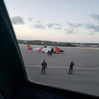 A U.S. Coast Guard helicopter crew walks an ailing mariner to an aircraft in Providenciales, Turks and Caicos, on Wednesday. The man was experiencing health complications aboard the tug Patriarch and needed higher level medical care. (U.S. Coast Guard photo)