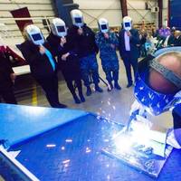 A welder authenticates the keel of LCS 21, the future USS Minneapolis-Saint Paul, by welding the initials of ship sponsor Jodi J. Greene. The Keel Laying is the formal recognition of the start of the ship's module construction process. Photo: Lockheed Martin