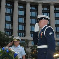 Adm. Robert J. Papp Jr., the Coast Guard Commandant, and Seaman John Kroll, a member of the Ceremonial Honor Guard, salute the statue of the ÒLone SailorÓ during the Coast Guard Dixieland Band Concert at the Navy Memorial Plaza, Aug. 3, 2010. The concert was held to honor the 220th birthday of the Coast Guard. U.S. Coast Guard photo by Petty Officer 1st Class Kip Wadlow. 