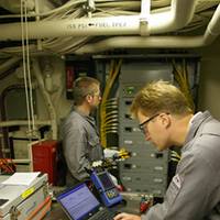 Alaris engineers perform an audit of energy use aboard a U.S. Coast Guard Cutter. (Photo courtesy Raina O Clark PR Cosulting)