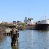 American Steamship Company’s M/V American Courage upbound on the Cuyahoga River in Cleveland, Ohio with a load of taconite from the iron ranges on Lake Superior for ArcelorMittal Cleveland, one of the most productive integrated steel mills in the world. (Photo Credit: Thomas Rayburn)