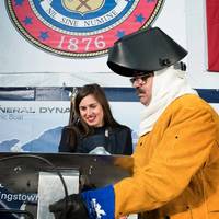 Annie Mabus chalked her initials into the keel of the nuclear submarine Colorado, which were then welded by Electric Boat employee John Alves (Photo courtesy of General Dynamics)