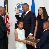 Anthony Foxx is sworn in as U.S. Secretary of Transportation by Judge Nathaniel Jones with wife, Samara, and children, Hillary and Zachary.