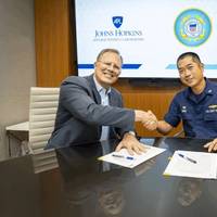 APL Assistant Director Tim Galpin and U.S. Coast Guard Research and Development Center commanding officer Capt. Michael Chien after signing a memorandum of understanding at APL on Aug. 5. The two institutions have teamed up to address critical technology challenges in national defense and maritime security. (Credit: Johns Hopkins APL/Craig Weiman)