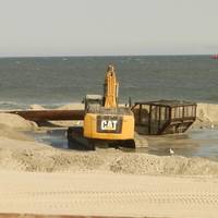 Bulldozers reconstruct the beach and dunes at Long Beach Island, New Jersey, as a dredge ship pumps sand from the Outer Continental Shelf to shore. Photo BOEM