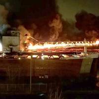 By 8:20 p.m. St. Clair's cargo conveyor boom had become completely engulfed in flames (Photo: Great Lakes Trader chief engineer / NTSB)