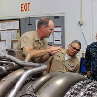 Capt. James S. Talbert, production officer at Norfolk Ship Support Activity, explains the change-out process of an LM2500 gas turbine engine to Rear Adm. Gregorio Martinez Nunez, Director of Mexican Navy General Staff, as Lt. Cmdr. Vargas interprets. (U.S. Navy photo by Art B. Ladle)