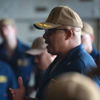 Capt. Lenard Mitchell, commanding officer of the expeditionary sea base USS Hershel "Woody" Williams (ESB 4) addresses the crew during an All Hands Call in the hangar bay. (Photo: Ridge Leoni / U.S. Navy)