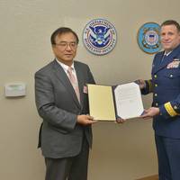 ClassNK Executive Vice President Dr. Takuya Yoneya (L) receives a copy of the Recognized Organization Agreement from U.S. Coast Guard Rear Admiral Joseph A. Servidio (R)