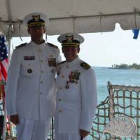 Coast Guard Cmdr. Craig J. Wieschhorster embraces Cmdr. Adam B. Morrison after taking command of the Coast Guard Cutter Mohawk
