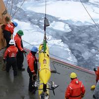 Coast Guard Cutter Healy deckhands prepare to lower an unmanned underwater vehicle, operated by the Woods Hole Oceanographic Institute, into the Beaufort Sea. WHOI scientists used the UUV to monitor ice conditions from below during the simulated exercise. (U.S. Coast Guard photo by Petty Officer 3rd Class Grant DeVuyst)