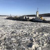 Coast Guard Cutter Penobscot Bay helps break free tug Brooklyn from the ice on the Hudson River near Saugerties, N.Y. (U.S. Coast Guard photo by Steven Strohmaier, courtesy of Coast Guard Cutter Penobscot Bay)