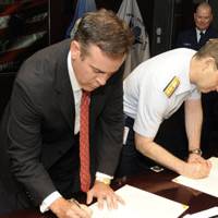 Coast Guard Rear Adm. Brian Salerno and Otto Candies, III, Vice Chairman of the Offshore Marine Services Association, sign a memorandum of understanding April 30, 2009, establishing the Offshore Support Vessel Industry Quality Partnership. This partnership promotes safety and security within the offshore industry and facilitates an open dialog between the Coast Guard and maritime stakeholders. (Coast Guard photo/Petty Officer 1st Class Mike Lutz)