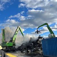 Commercial salvage excavators work to overhaul scrap metal that caught fire aboard a barge in the Newark Harbor on Oct. 22 2023. Coast Guard pollution responders supervise the operation to limit the opportunity of pollution entering the water. (Photo courtesy of Ken's Marine)