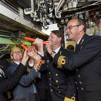 'Commodore Hans Lodder and Sytze Voulon of Imtech Marine Netherlands are cutting the cable in de commandcenter of Zr.MS. Zeeleeuw. From left Henk Jan Vink (TNO Director defence research), Commander Jouke Spoelstra, Sytze Voulon (Managing Director Imtech Marine Netherlands), Captain Marc lsensohn, Commodore Hans Lodder and Commander Danny van den Bosch. Photo: Ministry of Defence.’