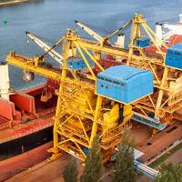Crane unloads iron or at a port - Credit; martinfredy/AdobeStock