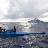 Crew members form U.S. Coast Guard Tactical Law Enforcement Detachment (LEDET) 111 and British Royal Navy team embarked aboard HMS Trent (P244) interdicts a semi-submersible drug smuggling vessel in the international waters of the Caribbean Sea, Aug. 26, 2024. Three suspected smugglers and 1,239 pounds of illegal narcotics from this interdiction were transferred to federal custody for prosecution by the U.S. Department of Justice. (Courtesy image from United Kingdom Royal Navy)