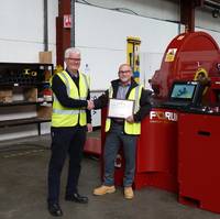 David Neill of TAM International (left) receives a plaque from George Hendry, business development manager for Forum AMC, recognising the purchase of the 350th RT torque machine. (Photo: TAM)