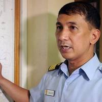 The Philippine coastguard spokesman points to the area on a map where a ferry went down on June 14, 2013 (AFP/File, Jay Directo)