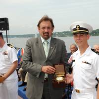 Ensign Jeffrey Iiams receives the Elmer A. Sperry Junior Navigator of the Year Award from Jeff Holloway of Northrop Grumman Corporation.