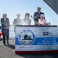 Foreground: Catherin B. Reynolds, left, and Ruby Lucas officially christen Jack H. Lucas (DDG 125). Observing in the background, (from left) Kari Wilkinson, Ingalls Shipbuilding president; U.S. Navy Adm. Michael Gilday, chief of naval operations; and U.S. Navy Capt. Brett Oster, DDG 125 prospective commanding officer. (Photo: Robert Hebert / HII)