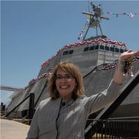 Former U.S. Rep. Gabrielle Giffords waves to a crowd in front of the littoral combat ship, USS Gabrielle Giffords (LCS 10), during the ship’s christening ceremony on June 13, 2015. US Navy photo.