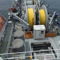 Offshore petroleum distribution system ship MV Vice Adm. K.R. Wheeler deploys yellow, flexible pipe to the seabed off the coast of Pohang, Republic of Korea, June 23. (U.S. Navy photo by Ed Baxter, Sealift Logistics Command Far East) 