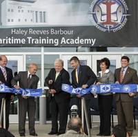 Haley Reeves Barbour (center), the former governor of Mississippi, officially opens the Maritime Training Academy, which bears his name. Also participating in the ribbon-cutting are (left to right) Mike Mangum, president, Jackson County Board of Supervisors; Mississippi State Sen. Brice Wiggins; Irwin F. Edenzon, president, Ingalls Shipbuilding; Mike Petters, president and CEO, Huntington Ingalls Industries; Dr. Mary Graham, president, Mississippi Gulf Coast Community College; and U.S. Rep. Stev