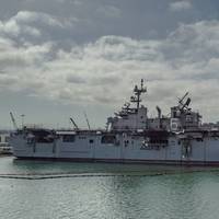 The fire-stricken amphibious assault ship USS Bonhomme Richard (LHD 6) sits pier side at Naval Base San Diego in July 2020. (Photo: Jason Waite / U.S. Navy)