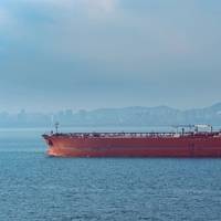 Illustration only - Crude oil tanker in front of Qingdao coastline - Credit: Igor Groshev - AdobeStock