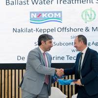 Dimitrios Tsoulos, Regional Sales Manager EMEA, De Nora Marine Technologies, (R) is joined by Georgios Moutzourogeorgos, Chief Commercial & Business Development Officer, NKOM, during the formal signing of the service subcontracting agreement with Nakilat-Keppel Offshore & Marine (N-KOM), to expand service convenience for De Nora Ballast Water Management Systems (BWMS) installed on vessels trading in the Gulf region. Image courtesy De Nora
